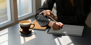 person-in-black-and-white-pinstripe-dress-shirt-using-tablet-3815573