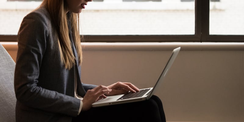 woman-sitting-down-and-using-laptop-on-her-lap-1181541-1